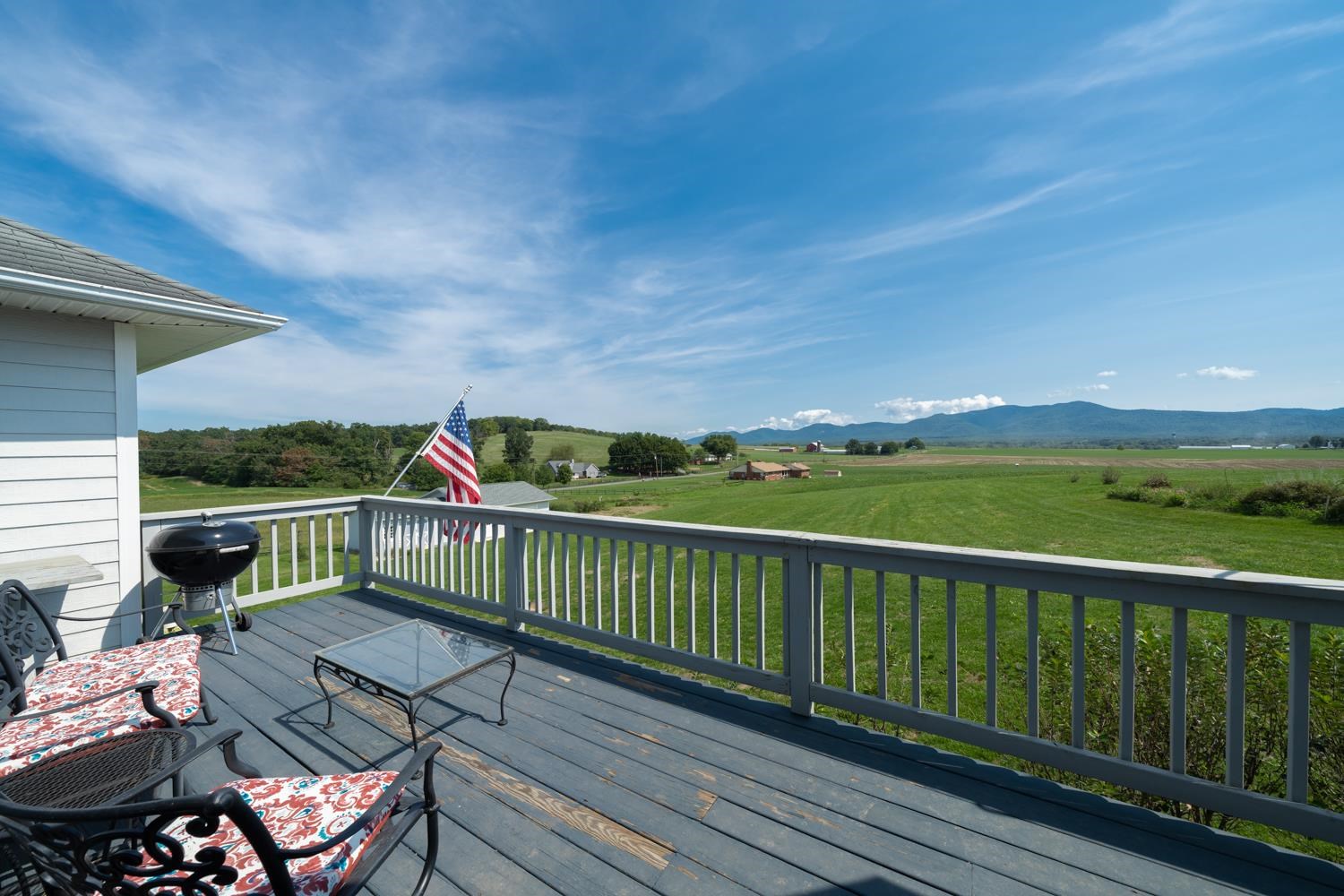 3751 Rockfish Road Grottoes, VA 24441 - Photo 35 of 60 a view of a balcony with wooden floor and outdoor seating