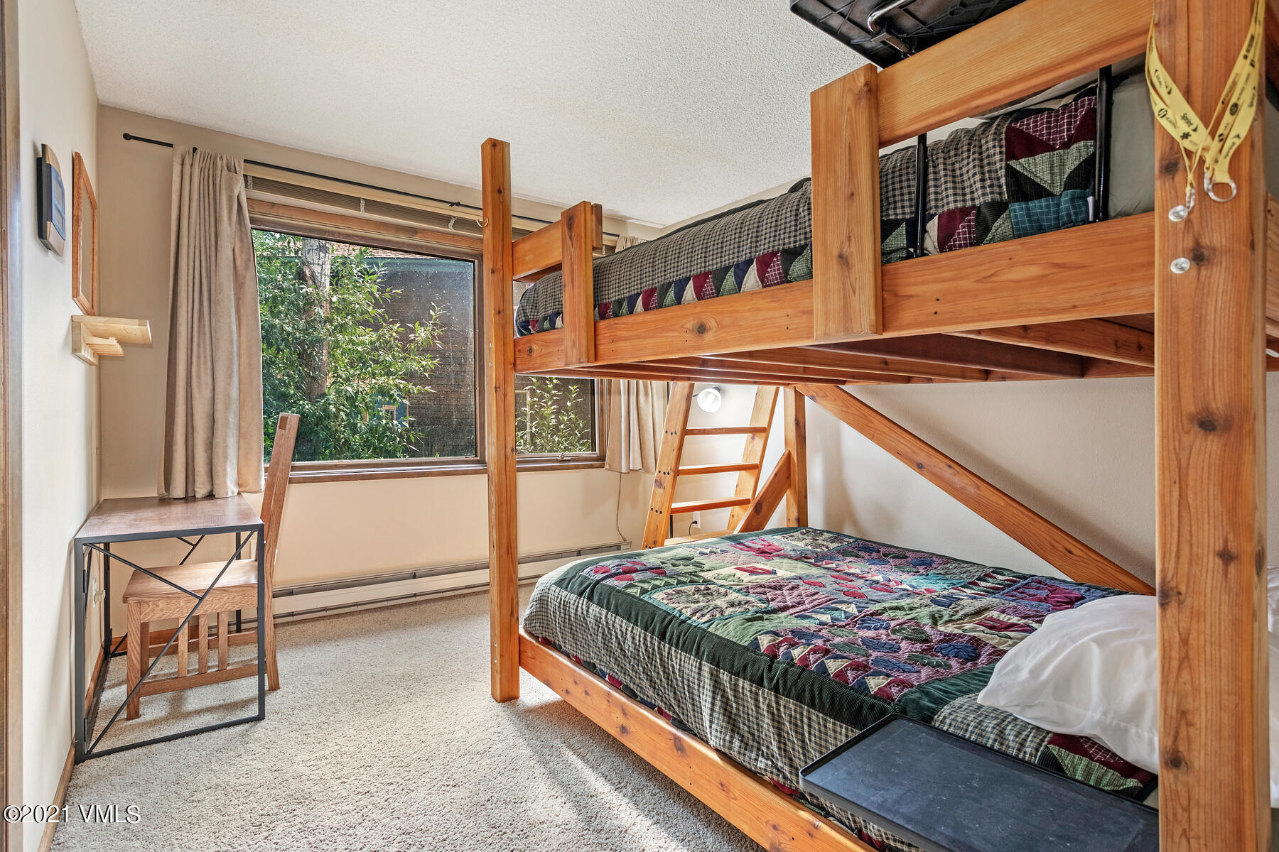 225 Gopher Road, Unit 46 Avon, CO 81620 - Photo 21 of 34 a view of a bedroom with a bed and glass door