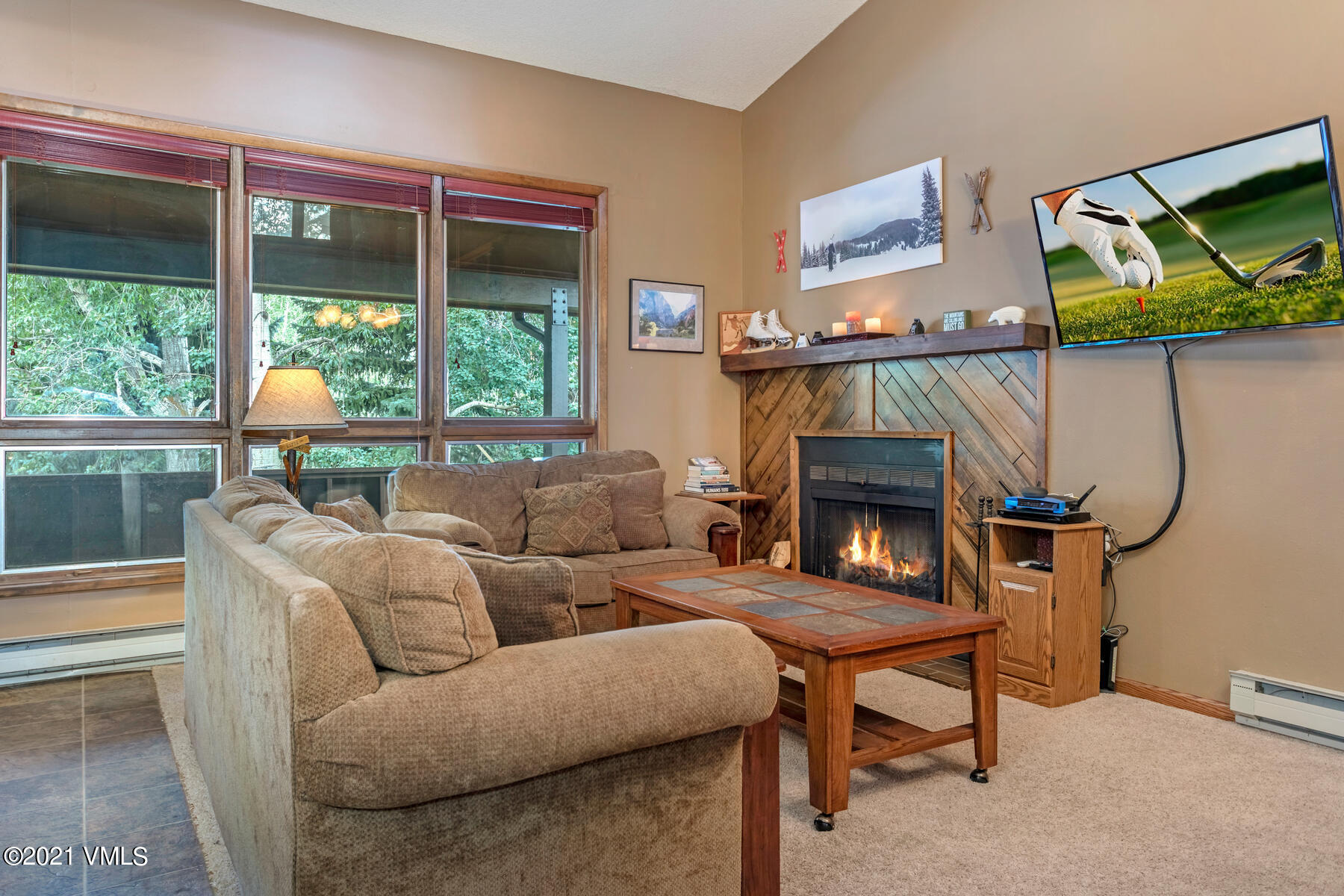 225 Gopher Road, Unit 46 Avon, CO 81620 - Photo 5 of 34 a living room with furniture a large window and a fireplace