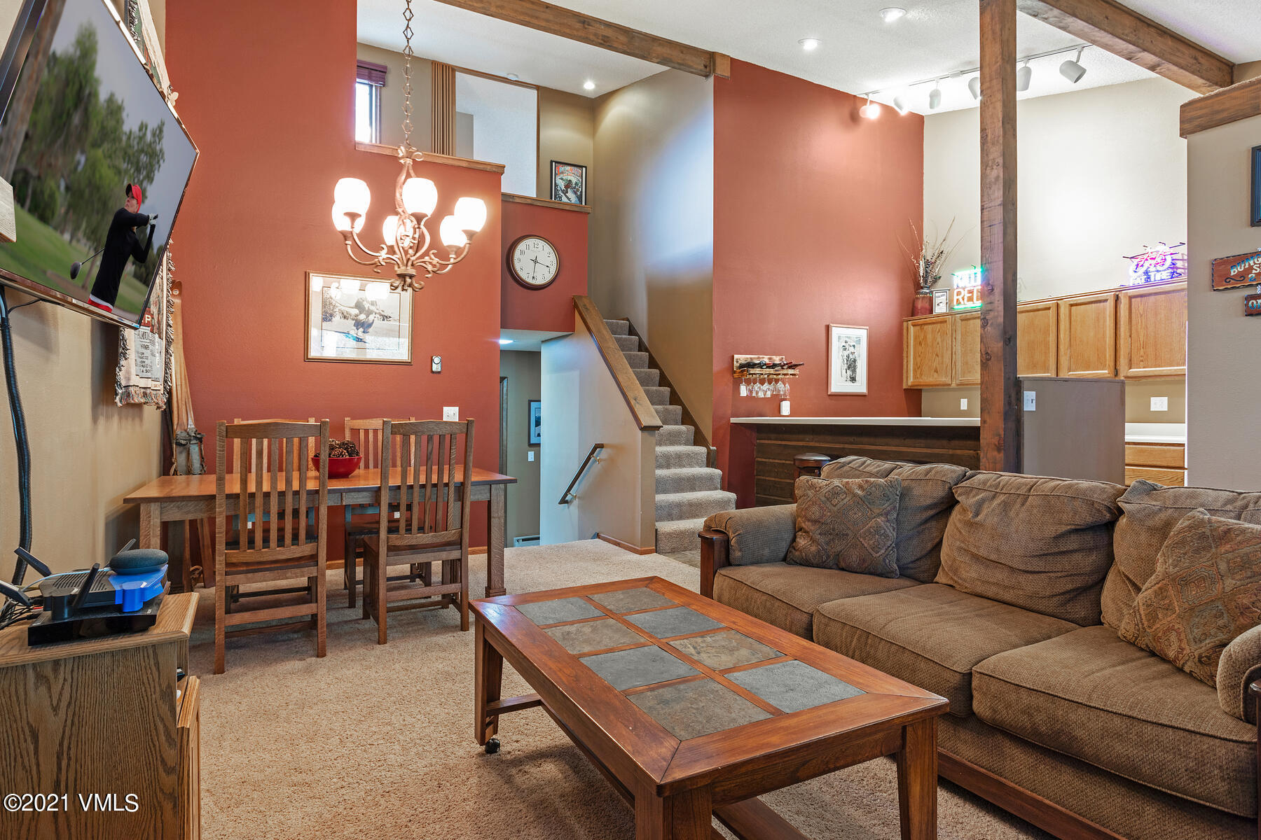 225 Gopher Road, Unit 46 Avon, CO 81620 - Photo 6 of 34 a living room with furniture a rug and a chandelier