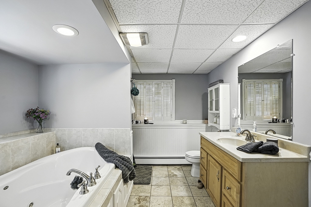 334 Mendon Road Northbridge, MA 01534 - Photo 22 of 31 a bathroom with a tub sink and mirror