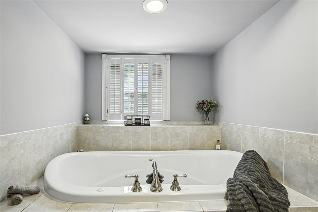 334 Mendon Road Northbridge, MA 01534 - Photo 24 of 31 a bath tub sitting in a bathroom next to a window
