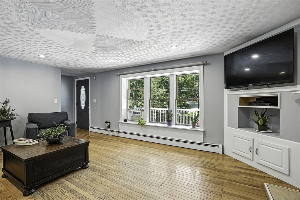 334 Mendon Road Northbridge, MA 01534 - Photo 5 of 31 a living room with furniture and a flat screen tv
