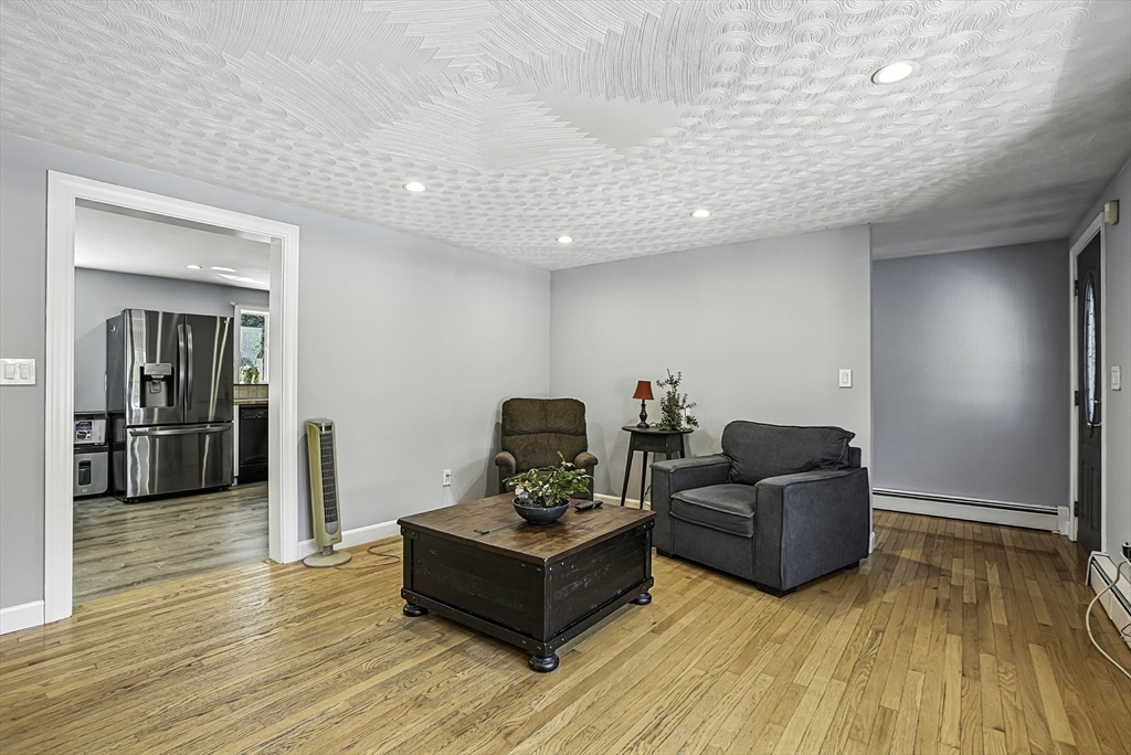 334 Mendon Road Northbridge, MA 01534 - Photo 7 of 31 a living room with furniture and a wooden floor