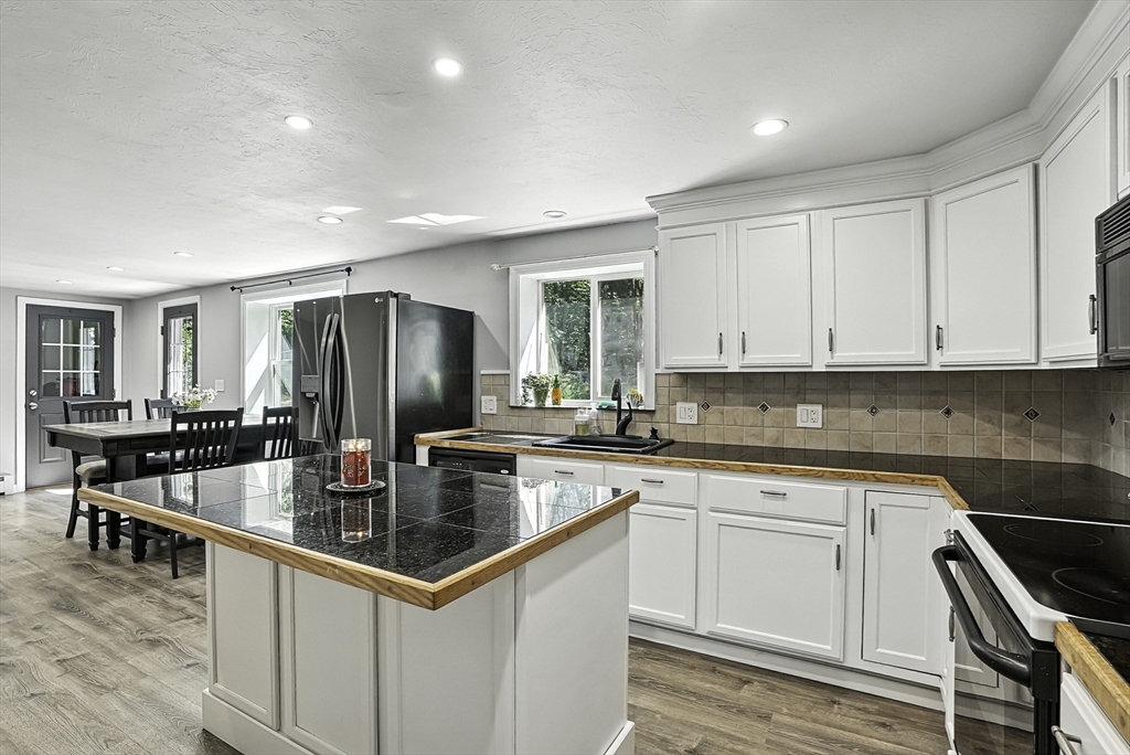 334 Mendon Road Northbridge, MA 01534 - Photo 8 of 31 a kitchen with stainless steel appliances granite countertop a sink stove and refrigerator