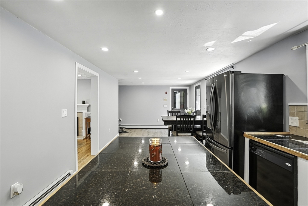 334 Mendon Road Northbridge, MA 01534 - Photo 9 of 31 a kitchen with stainless steel appliances a refrigerator and wooden floor