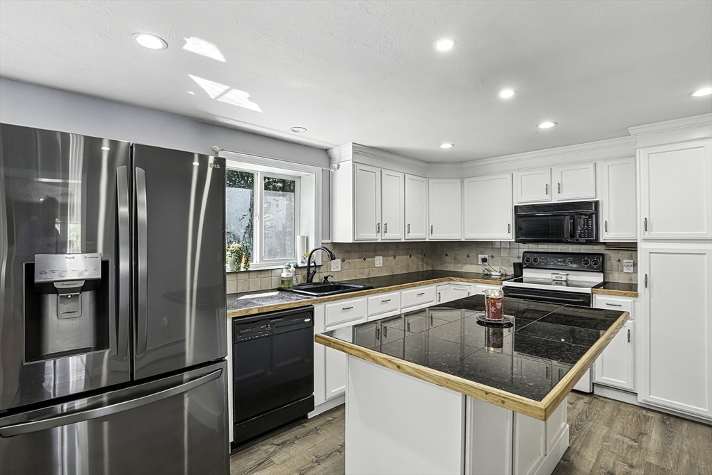 334 Mendon Road Northbridge, MA 01534 - Photo 10 of 31 a kitchen with a sink stainless steel appliances and cabinets