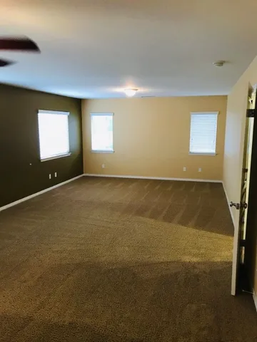a view of a hallway with wooden floor and entryway