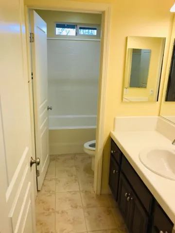a view of a big room with closet and chandelier fan