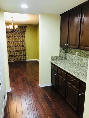 a large kitchen with stainless steel appliances and a large window