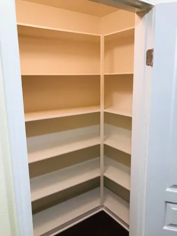 a view of kitchen with stainless steel appliances granite countertop a refrigerator and a sink