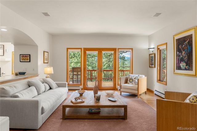 a living room with furniture and large windows