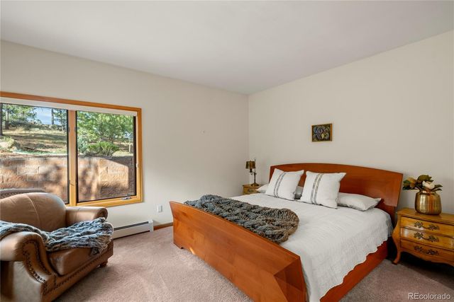 a bedroom with a bed and glass window
