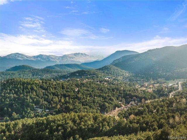 a view of a town with mountains in the background