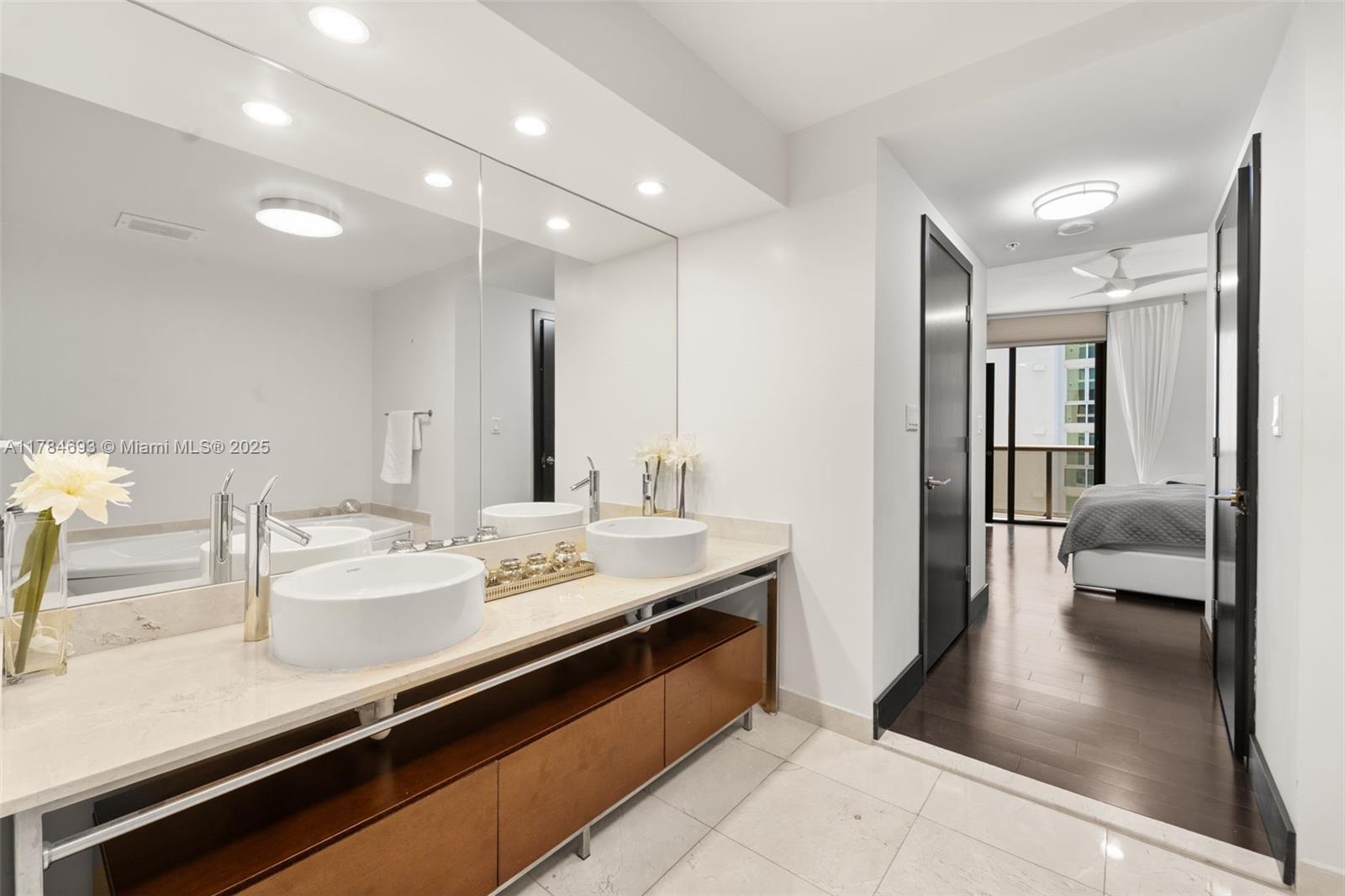 16275 Collins Avenue, Unit 2202 Sunny Isles Beach, FL 33160 - Photo 11 of 23 a en suite bathroom with a sink double vanity and a mirror