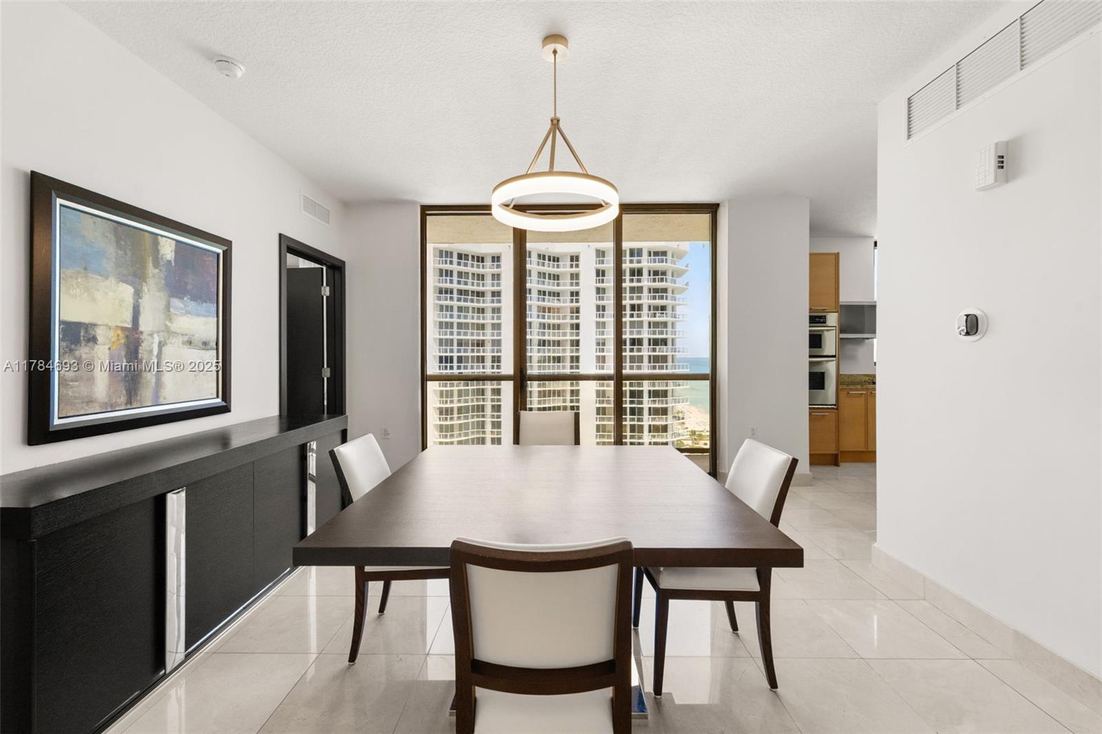 16275 Collins Avenue, Unit 2202 Sunny Isles Beach, FL 33160 - Photo 5 of 23 a view of a dining room with furniture window and outside view