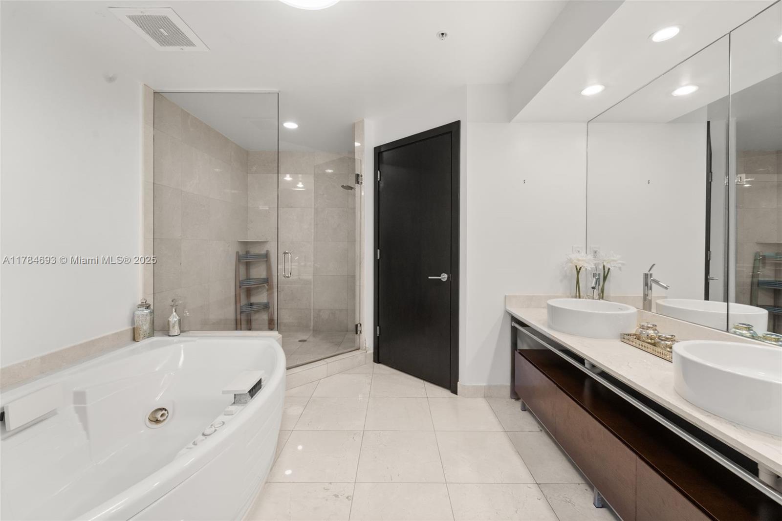 16275 Collins Avenue, Unit 2202 Sunny Isles Beach, FL 33160 - Photo 10 of 23 a spacious bathroom with a tub sink and mirror