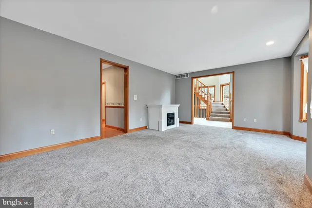 a large kitchen with stainless steel appliances granite countertop a large window a sink and cabinets