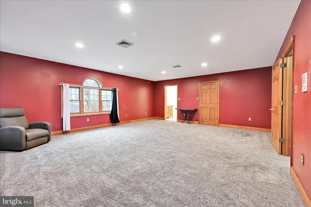 a view of an empty room with windows