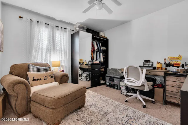 a livingroom with workspace and a couch