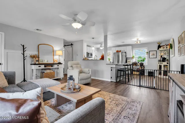 a living room with furniture and wooden floor
