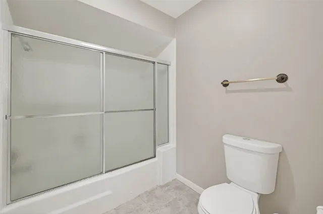 a bathroom with a shower and a glass door