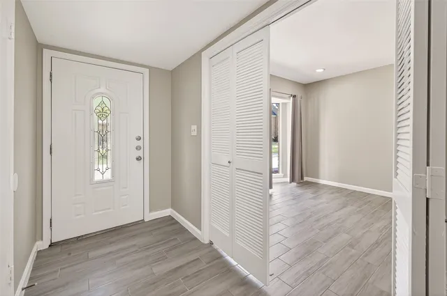 wooden floor in an empty room with a window