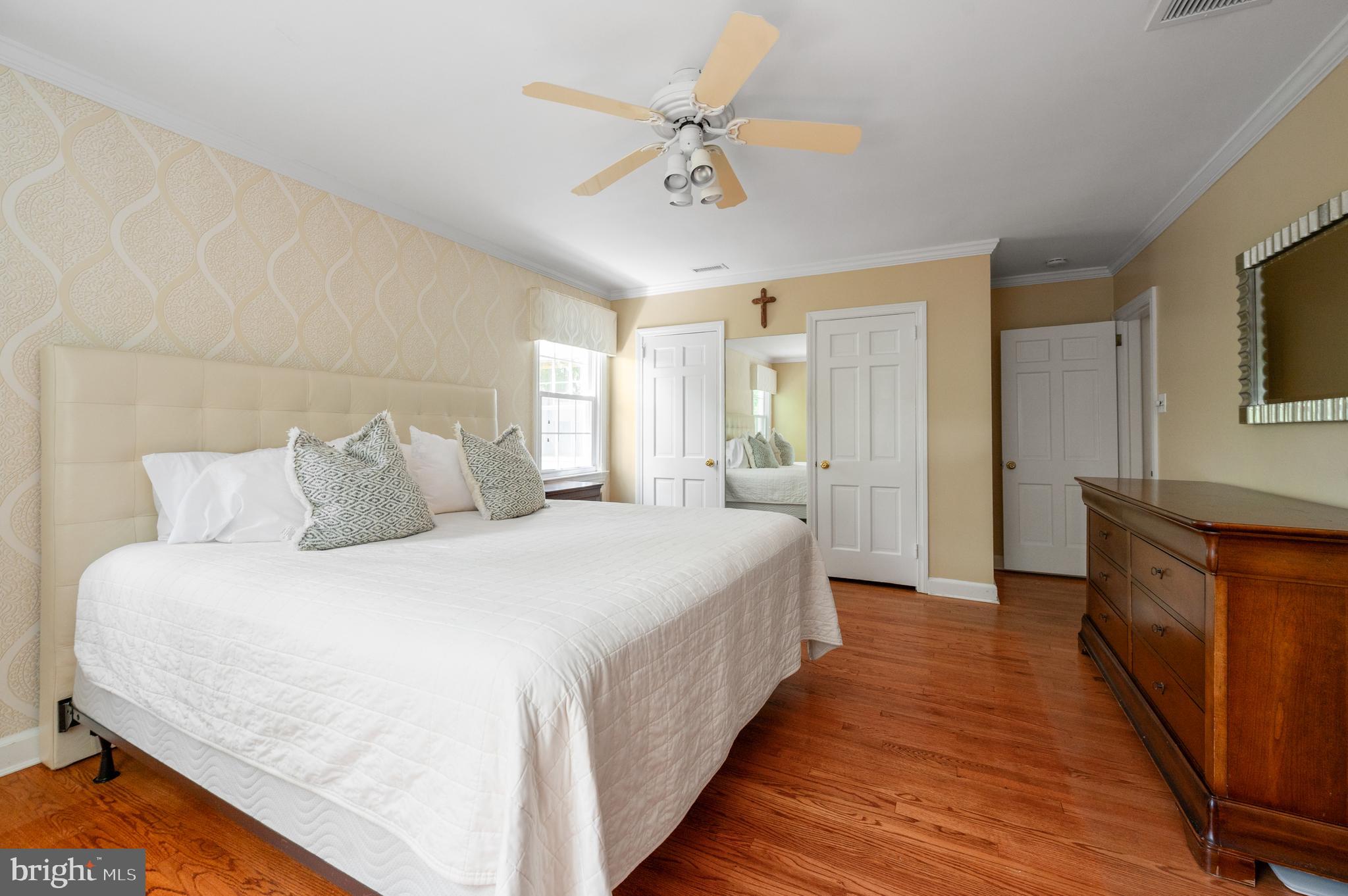 653 Broad Acres Road Penn Valley, PA 19072 - Photo 24 of 35 a spacious bedroom with bed and a chandelier