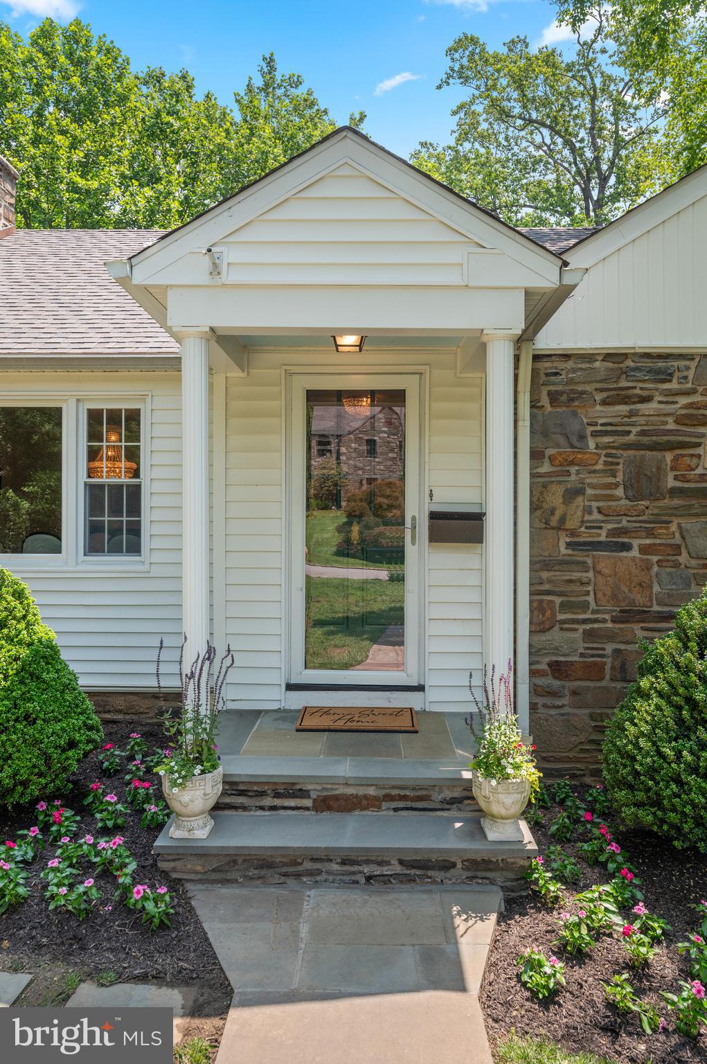 653 Broad Acres Road Penn Valley, PA 19072 - Photo 4 of 35 a front view of a house with a garden