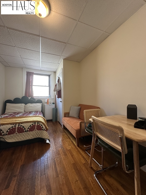 505 Beacon Street, Unit 12 Boston, MA 02215 - Photo 1 of 5 a living room with a bed and a table