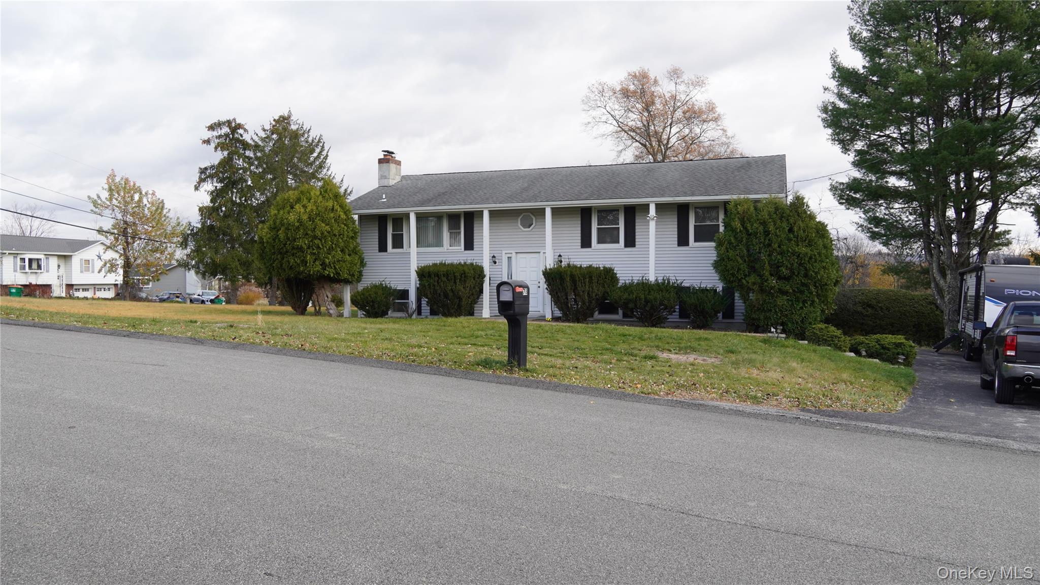Split foyer home with a front yard and a chimney
