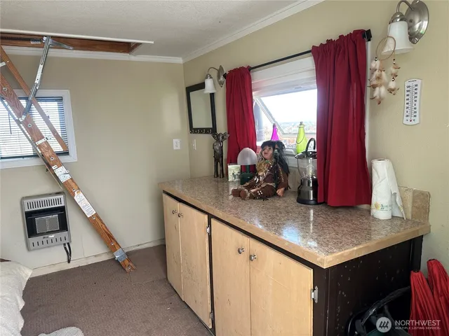 a view of hallway with furniture and a window