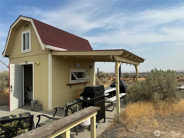 a backyard of a house with table and chairs