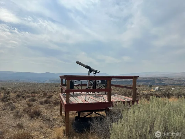 a balcony with table and chairs