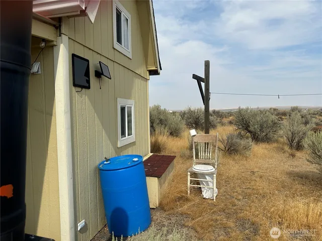 a view of a balcony with furniture and a floor to ceiling window