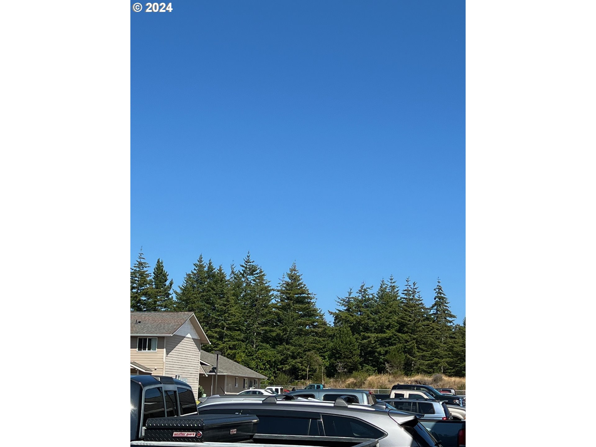 1150 Hemlock Street, Unit D14 Florence, OR 97439 - Photo 14 of 15 a car parked in front of a white building