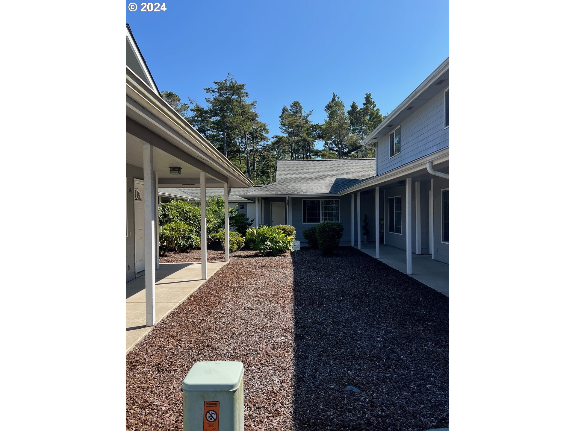 1150 Hemlock Street, Unit D14 Florence, OR 97439 - Photo 2 of 15 a view of a house with a yard and potted plants
