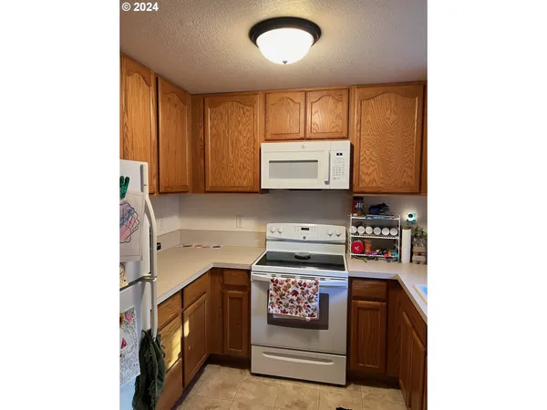 a view of kitchen with stove and microwave