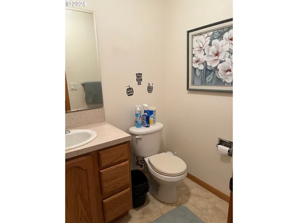 a bathroom with a toilet a sink and mirror