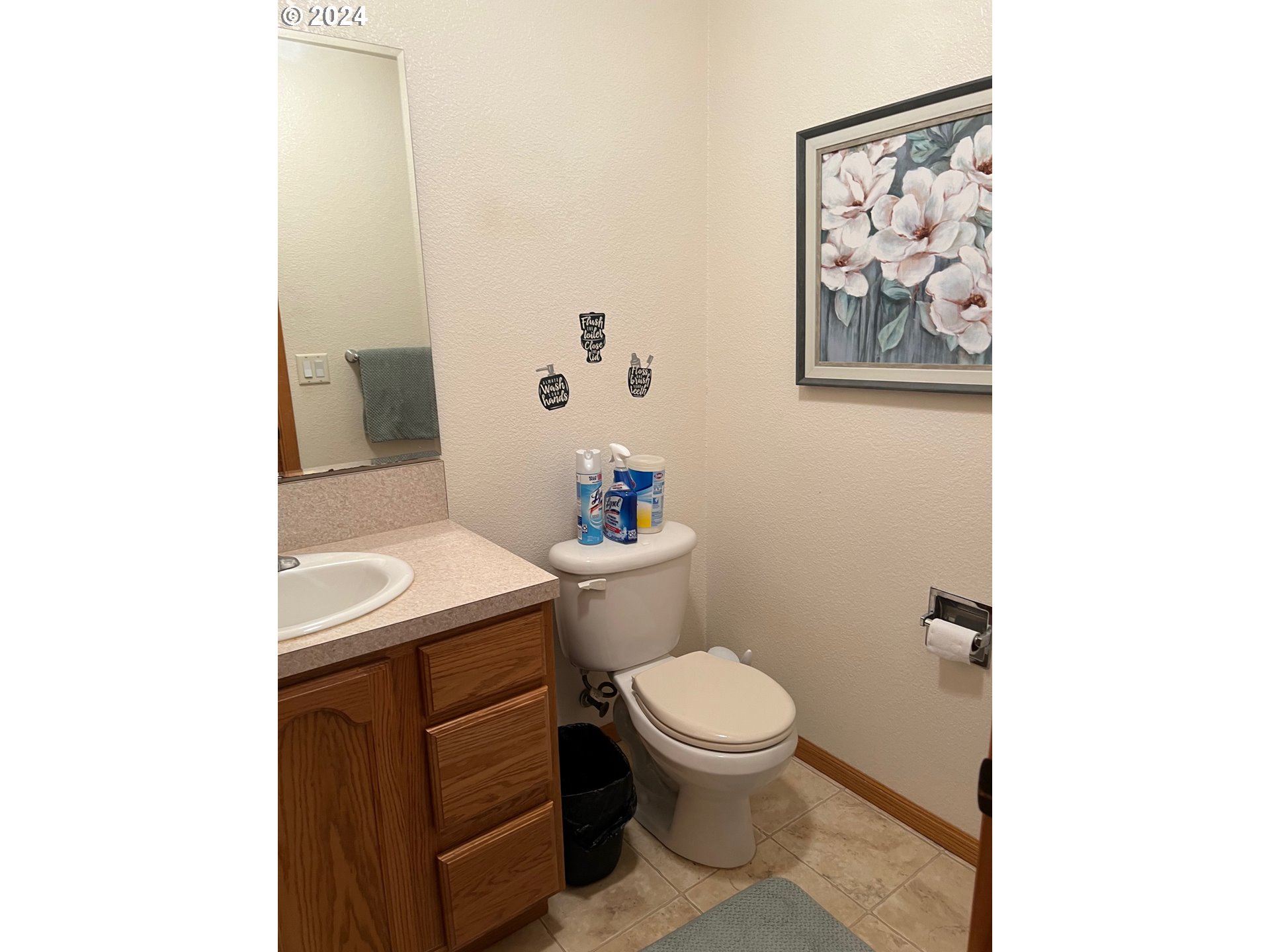 1150 Hemlock Street, Unit D14 Florence, OR 97439 - Photo 8 of 15 a bathroom with a toilet a sink and mirror