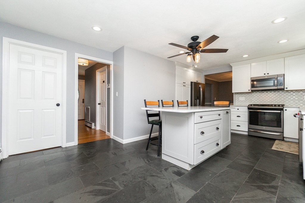 63 Bow Street Saugus, MA 01906 - Photo 10 of 42 a kitchen with stainless steel appliances cabinets and a ceiling fan