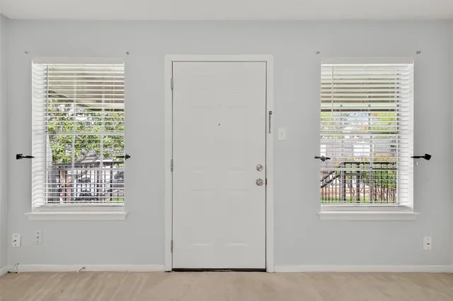 a view of an empty room with windows