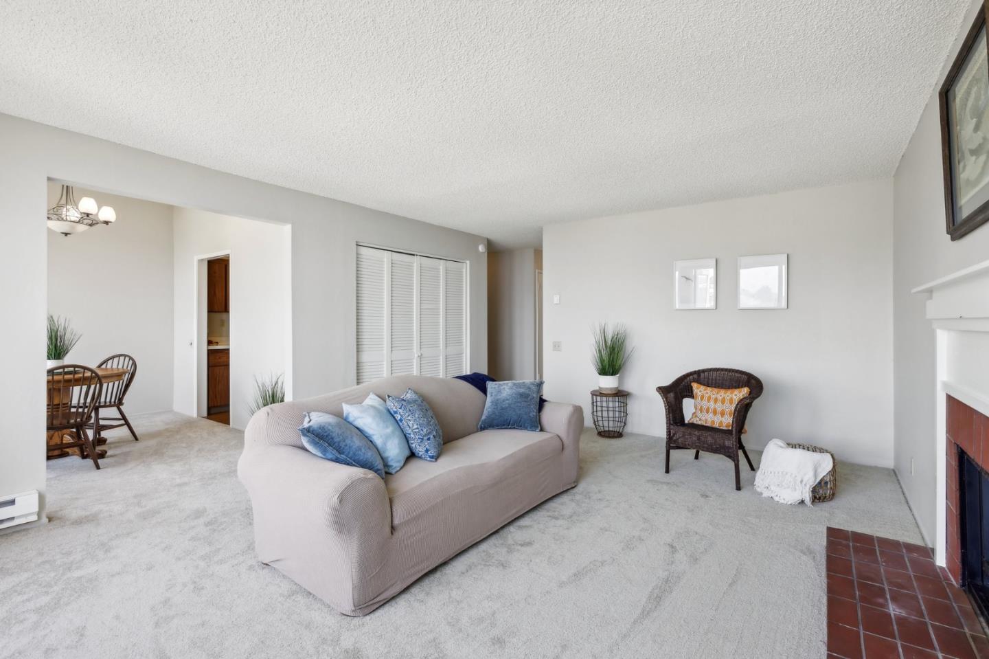 5003 Palmetto Avenue, Unit 89 Pacifica, CA 94044 - Photo 12 of 46 a living room with furniture and a potted plant on table