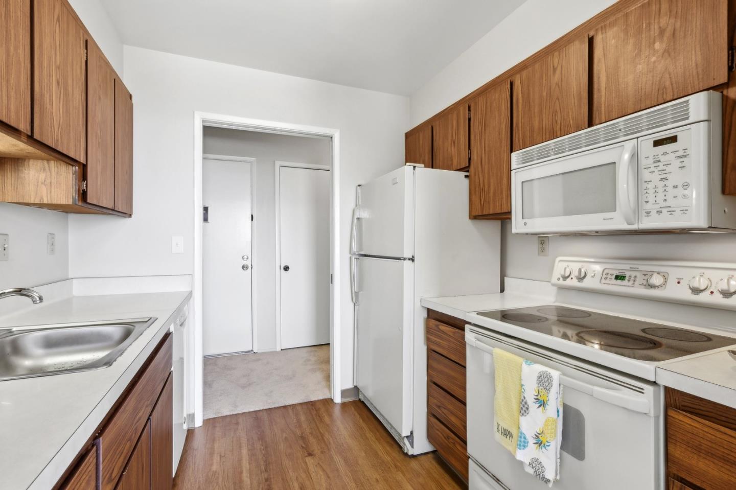 5003 Palmetto Avenue, Unit 89 Pacifica, CA 94044 - Photo 20 of 46 a kitchen with a refrigerator sink and stove