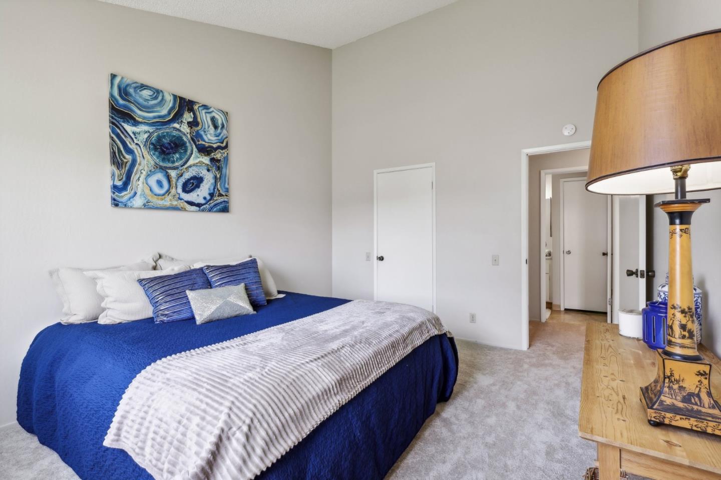 5003 Palmetto Avenue, Unit 89 Pacifica, CA 94044 - Photo 24 of 46 a bedroom with bed and a lamp