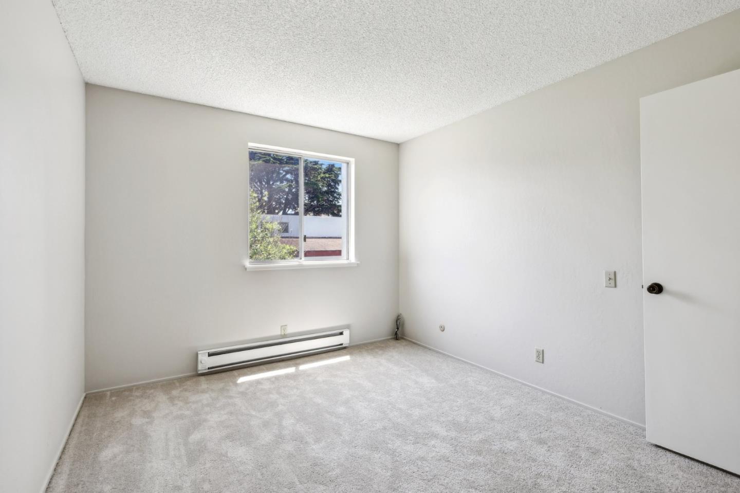 5003 Palmetto Avenue, Unit 89 Pacifica, CA 94044 - Photo 25 of 46 an empty room with windows