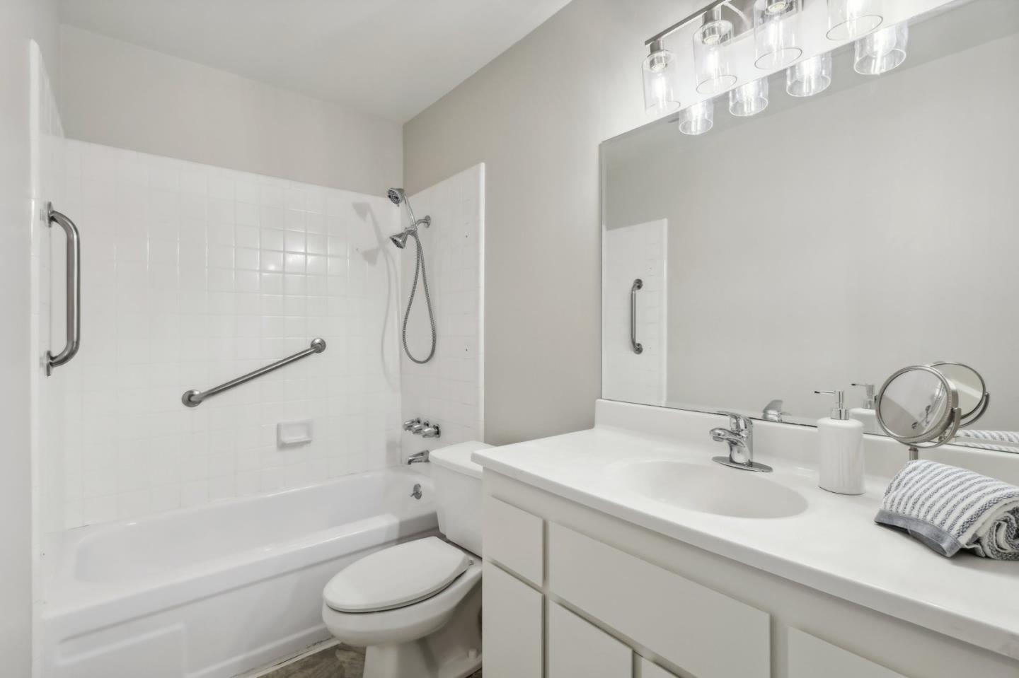 5003 Palmetto Avenue, Unit 89 Pacifica, CA 94044 - Photo 27 of 46 a bathroom with a sink a toilet and a mirror