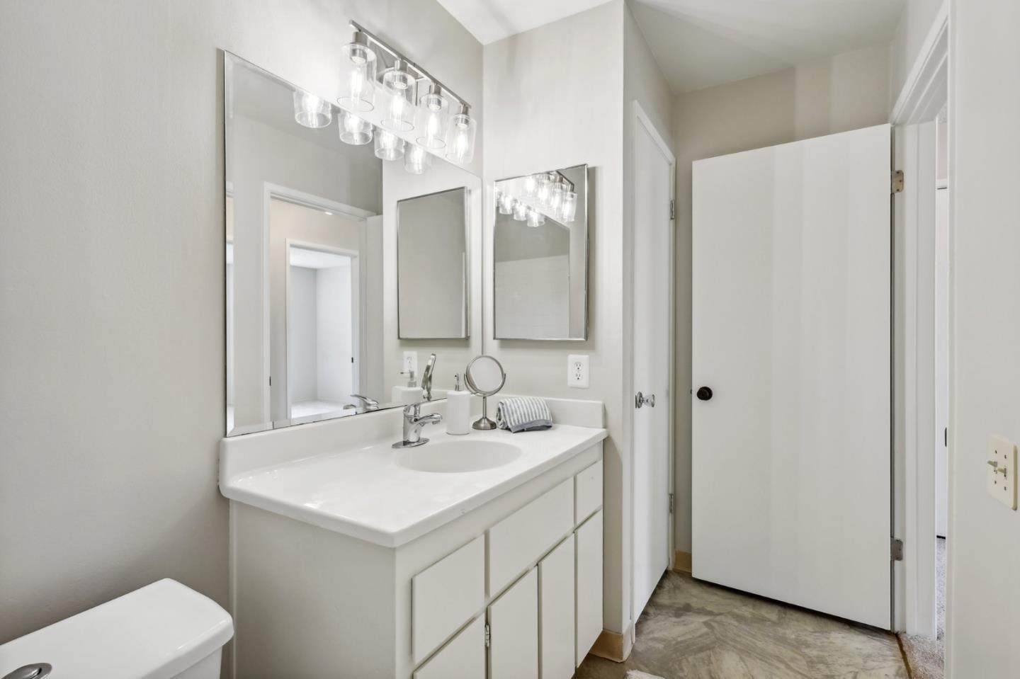 5003 Palmetto Avenue, Unit 89 Pacifica, CA 94044 - Photo 28 of 46 a bathroom with a sink and a mirror