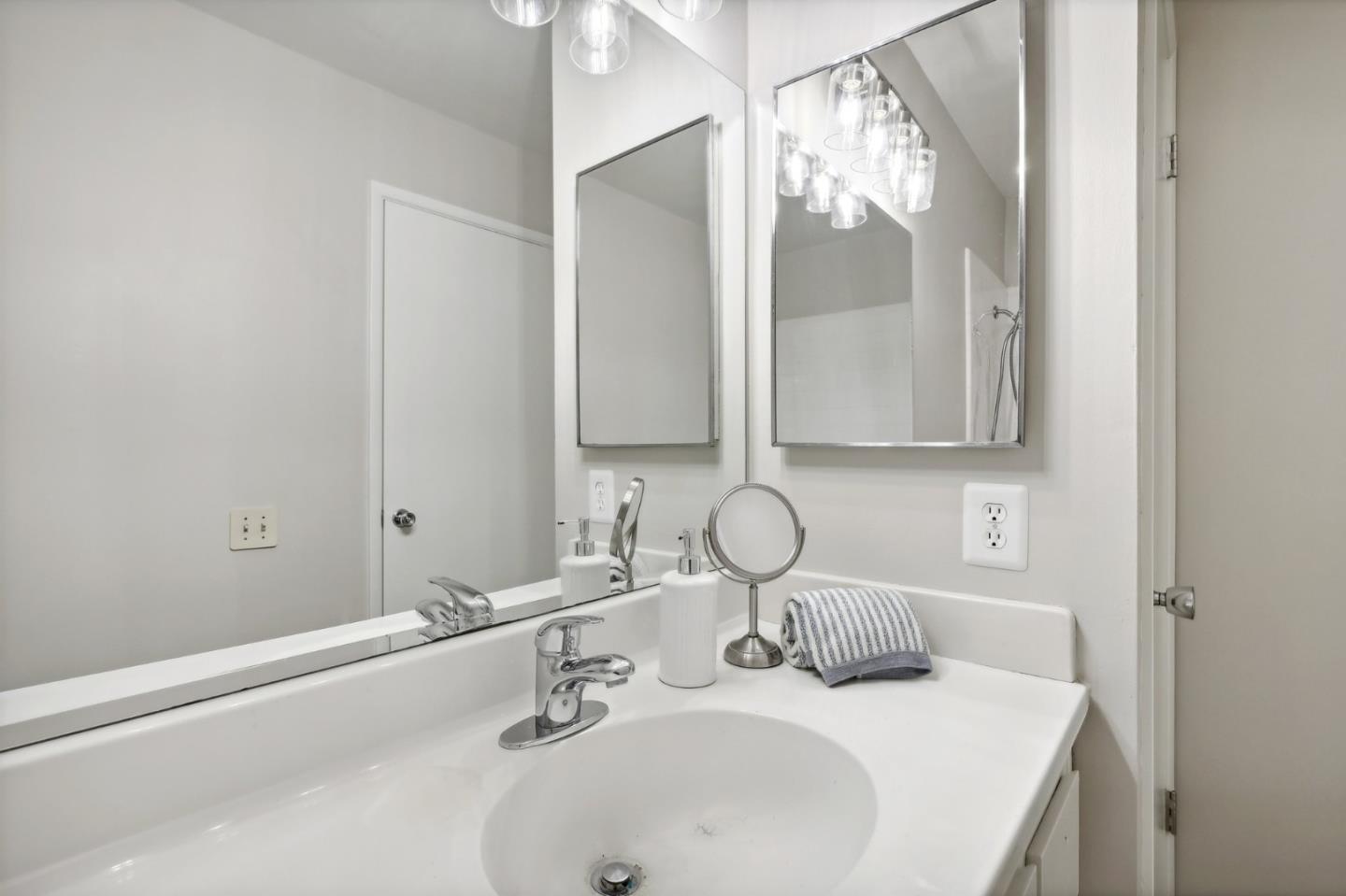 5003 Palmetto Avenue, Unit 89 Pacifica, CA 94044 - Photo 29 of 46 a bathroom with a sink and a mirror