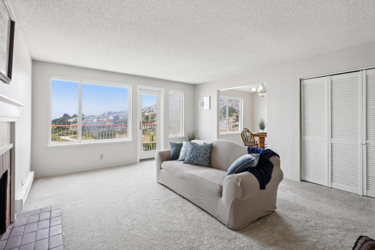 5003 Palmetto Avenue, Unit 89 Pacifica, CA 94044 - Photo 8 of 46 a living room with furniture and a large window